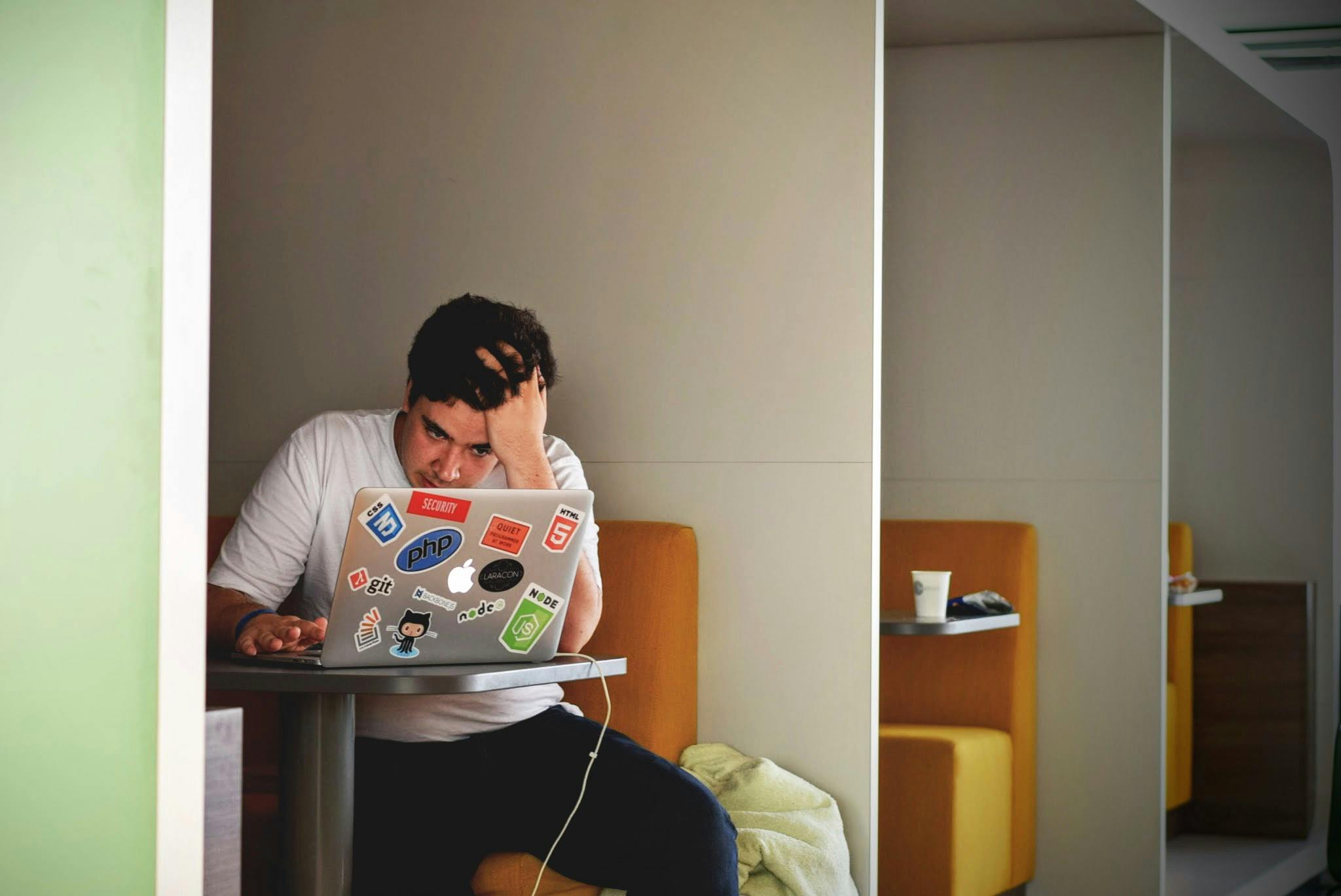 A frustrated person looking at a slow computer - it maintenance for businesses