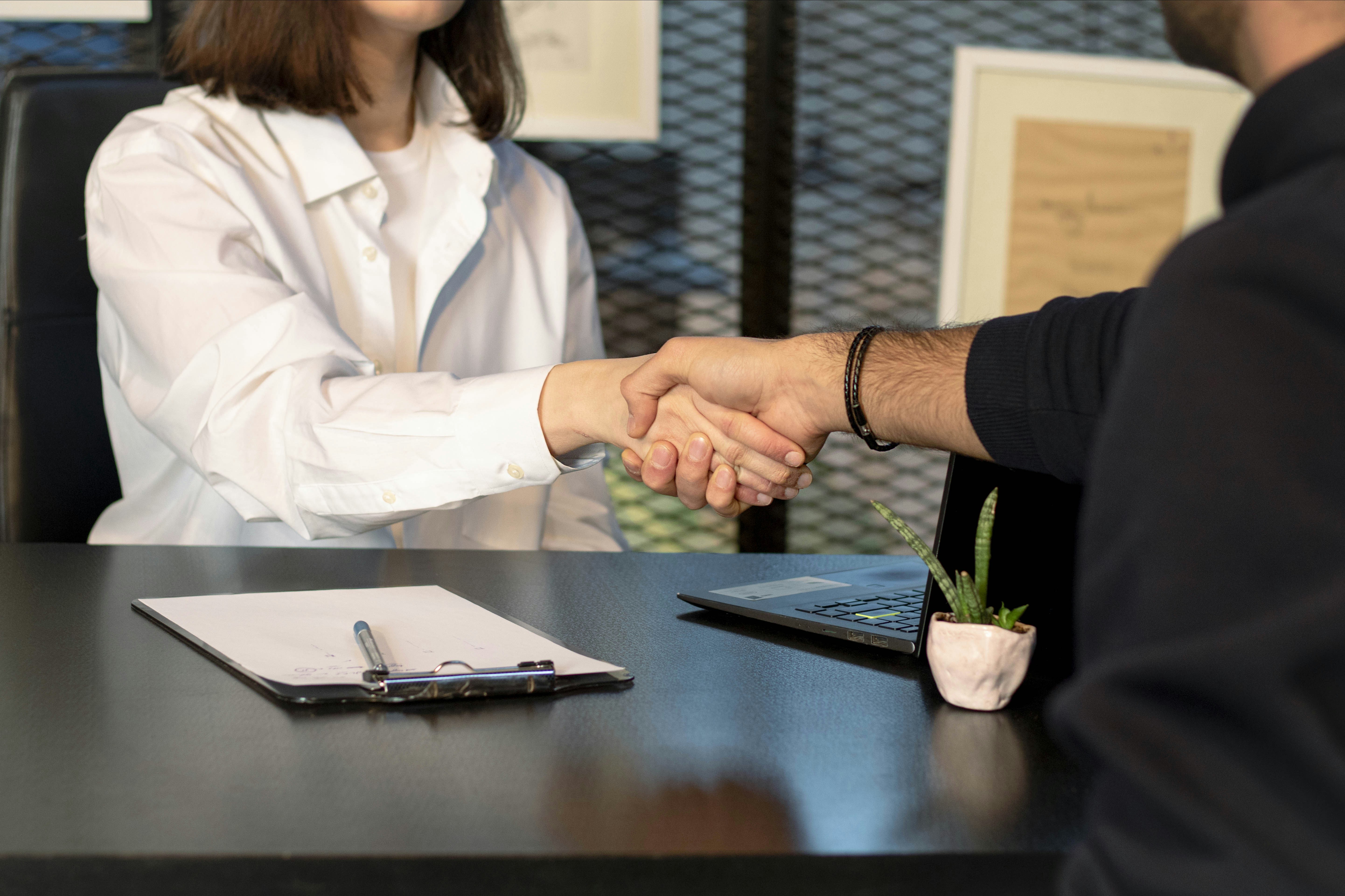 successful job interview handshake - web designer houston